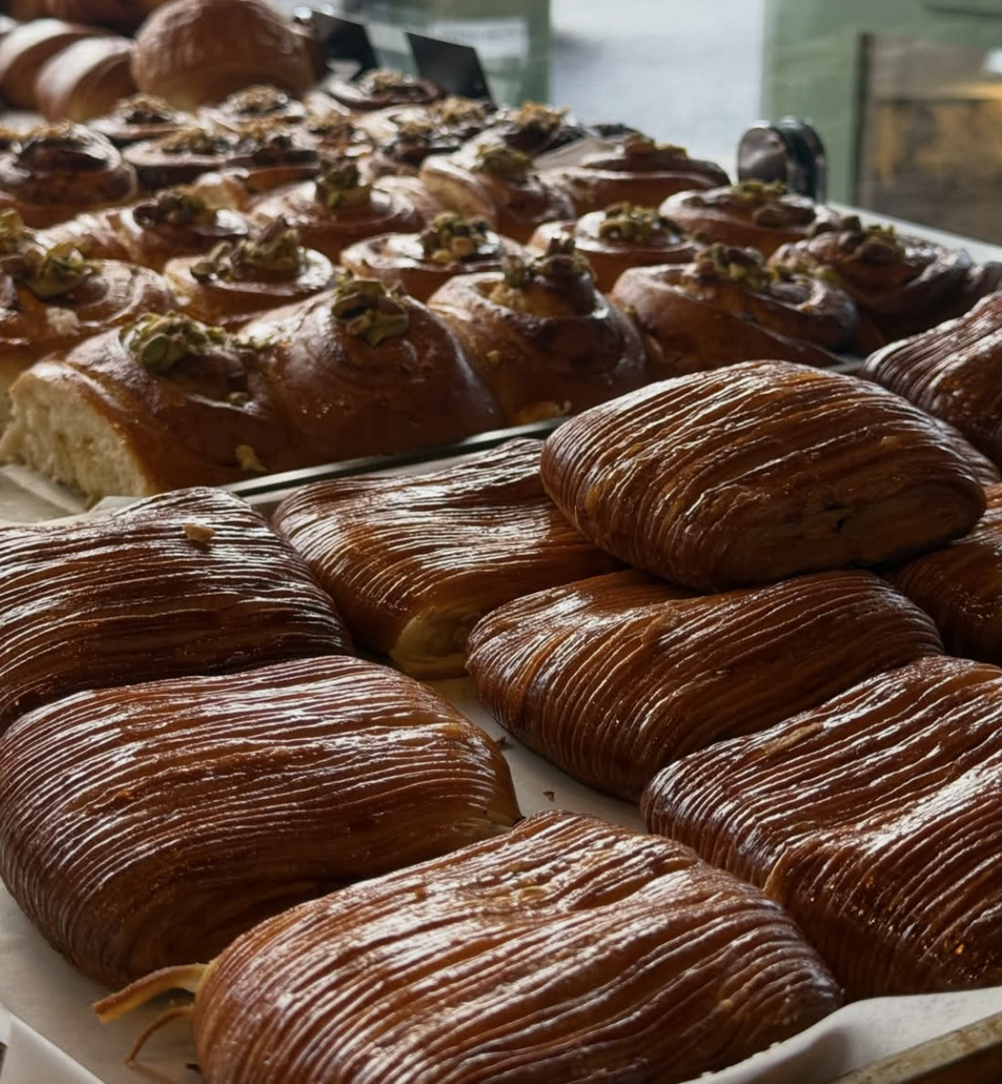 Pistachio brioche buns and flaky sfogliatelle pastries.